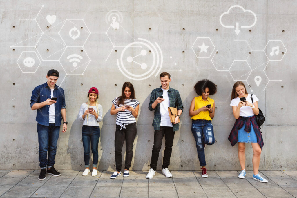 A group of people standing with their mobile devices