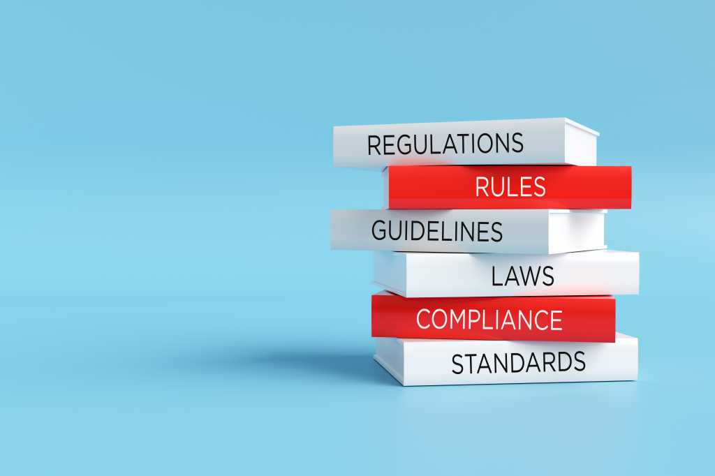 “Designed for Stability, Facing Chaos: How AI Rewrites Cybersecurity’s Playbook” Books forming a stack with words regulations, rules, guidelines, laws, compliance and standards, compliance concept. 3D render.