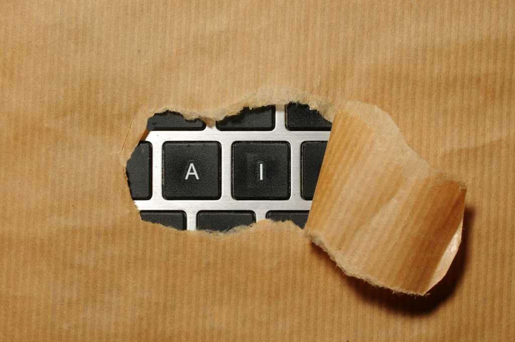 AI Alarm: Hackers Weaponize Automation—Incident Response Under Siege A piece of cardboard with AI on a keyboard appearing through it