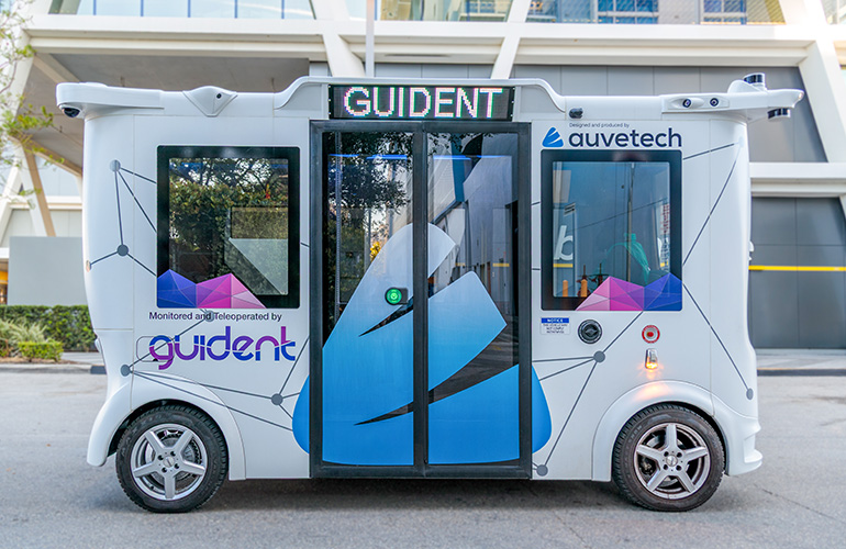 Beyond the Test Track: Navigating California’s AV Maze of Tickets, Virtual Boundaries, and a Million Miles of Rules side view of the auvetech autonomous vehicle. Guident is managing it in Florida while monitoring regulatory changes in California.