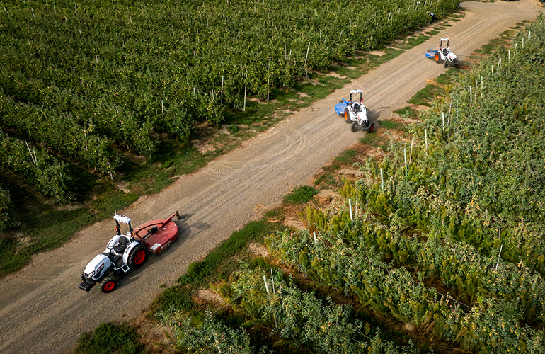 Agtonomy Unveils Precision Swarm: Autonomous Multi-Point Turning Revolution agtonomy tractors shown from a drone shot, turning around on a narrow dirt path between fields.