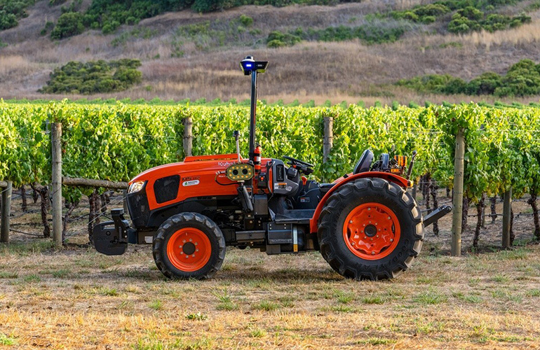 The next big AI play isn’t apps or humanoids; it’s machines with brains and brawn Kubota tractor equipped with agtonomy controls in front of a vineyard.