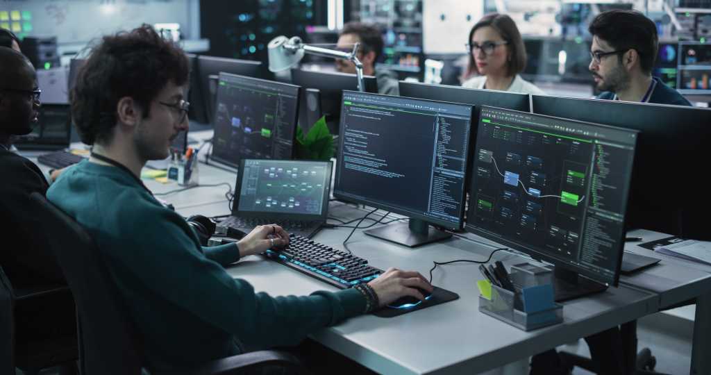 Cybersecurity Careers Have Changed Forever—Here Are 5 Ways AI Is Leading the Shift Team of Diverse Multiethnic Software Developers Working on Computers, Programming Advanced Code, Managing Artificial Intelligence Projects Online for Innovative Cybersecurity Technology Company