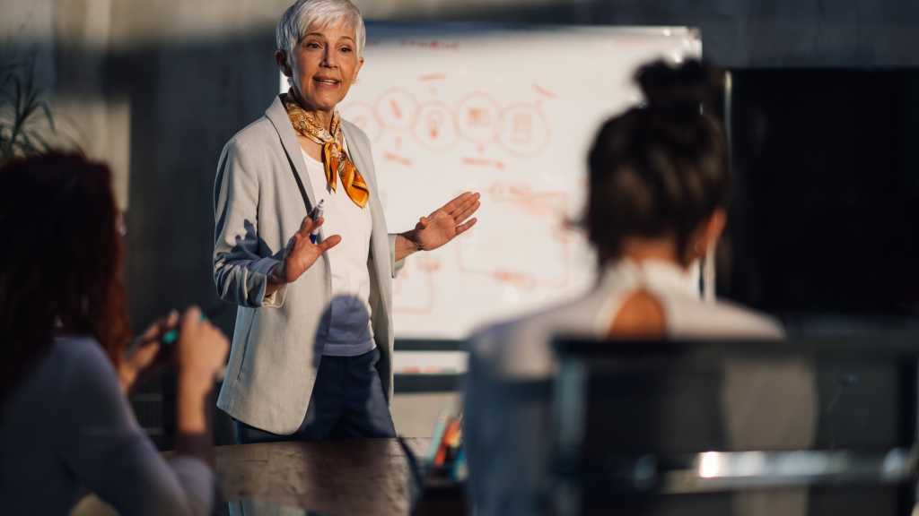 The Rising CISOs of 2026: Leading the Charge in Cyber Defense image of Mature female executive speaking at important meeting